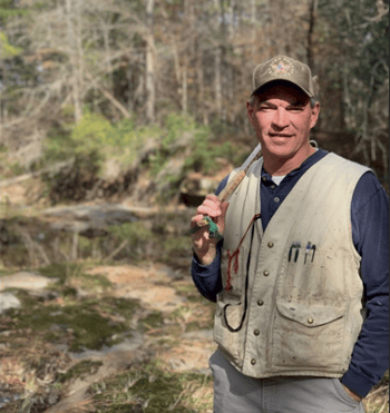Consulting Forester Wayne Pfluger standing in the woods Consulting Forester Wayne Pfluger standing in the woods